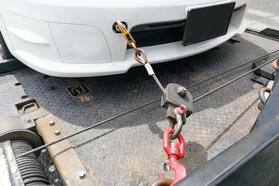 Car Towed Onto Flatbed Tow Truck With Hook And Chain long distance of car towing